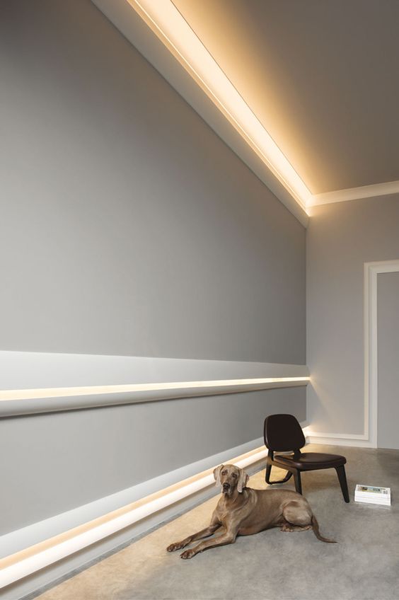 a neutral contemporary interior accented with crown molding and with indirect light over it is a very cool idea