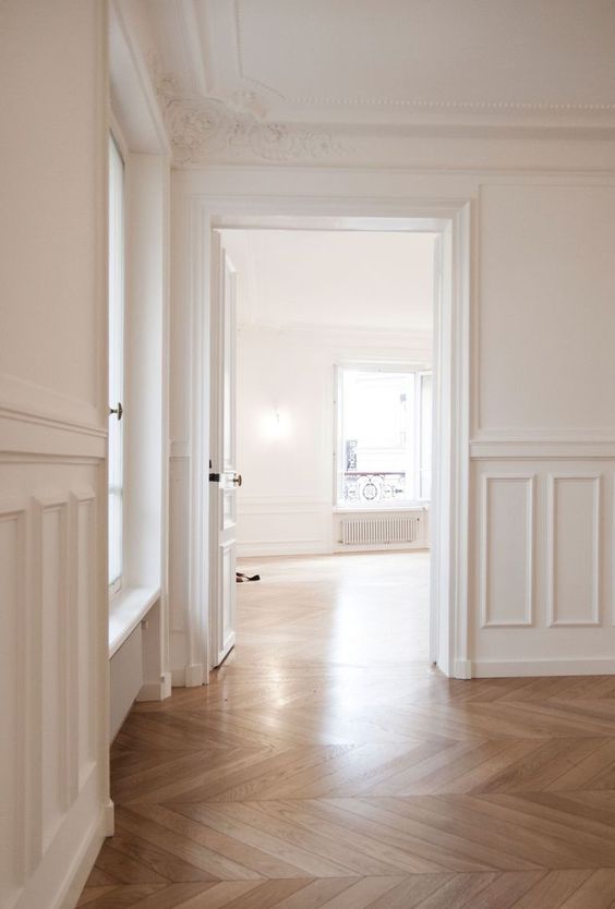 a neutral space with crown molding covering the doorways and ornated crown molding on the ceiling for a more sophisticated look