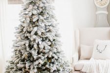a perfect flocked Christmas tree with oly lights and nothing else is a gorgeous idea for a winter wonderland Christmas party