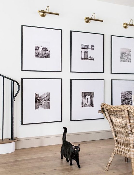 https://www.digsdigs.com/photos/2021/11/a-statement-grid-gallery-wall-with-matching-black-frames-and-black-and-white-artworks-with-matting-is-a-stylish-idea-to-rock.jpg