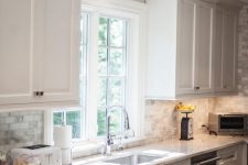 crown molding that matches the cabinets in color makes the space look higher than it is and is a cool solution