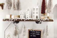 winter wonderland decor – shelves with pompoms, bottle brush Christmas trees and houses is amazing and easy to realize