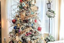 02 a creative and bright flocked Christmas tree with bold ornaments, letter garlands, a Sorting Hat topper, owls, branches and pinecones