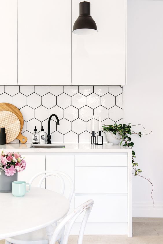 a white Scandinavian kitchen with a bit of black touches for a contrast and hex tile sticker panels on the backsplash to make it more awesome