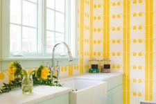 09 a colorful welcoming kitchen with yellow print wallpaper walls, a mint frame window and mint cabinets for a bold look