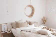 11 a beautiful modern boho bedroom with wooden furniture, a neon sign, a pampas grass wreath and neutral bedding