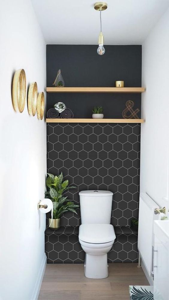 a small and stylish mudroom with a black wall accented with white hexagon vinyl tile stickers is amazing
