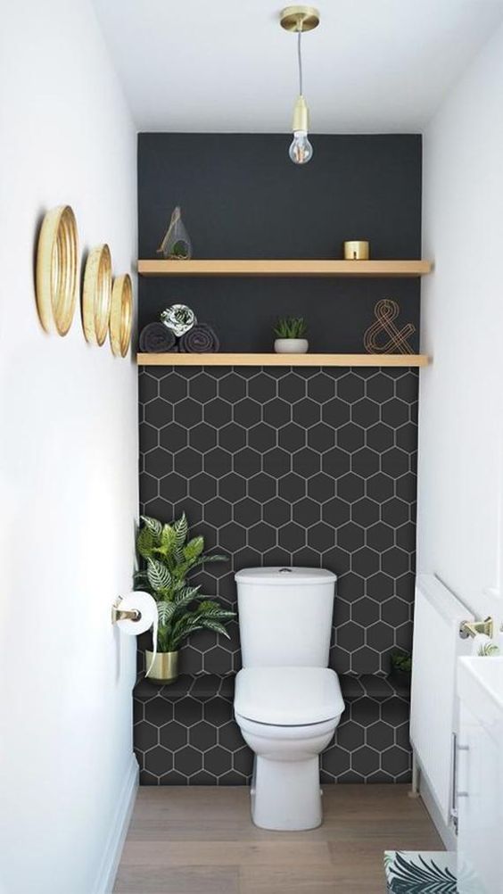 a small and stylish mudroom with a black wall accented with white hexagon vinyl tile stickers is amazing