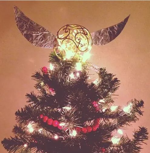 a gorgeous Christmas tree topper shaped as a shiny Golden Snitch is a fantastic idea for a Harry Potter Christmas party