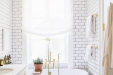 18 a vintage black clawfoot bathtub and black grout with subway tiles bring more chic to the space