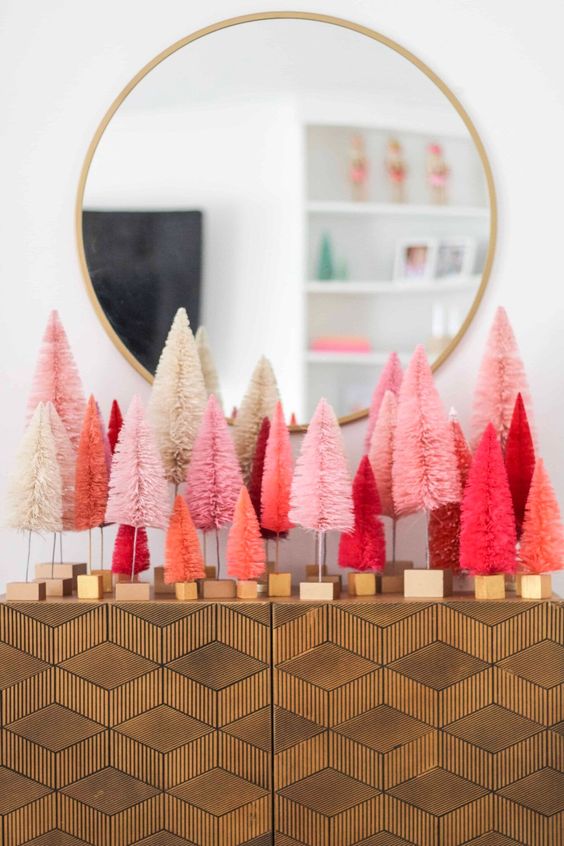 style your elegant console table with white, blush, pink, coral and hot red bottle brush Christmas tree for a bold look