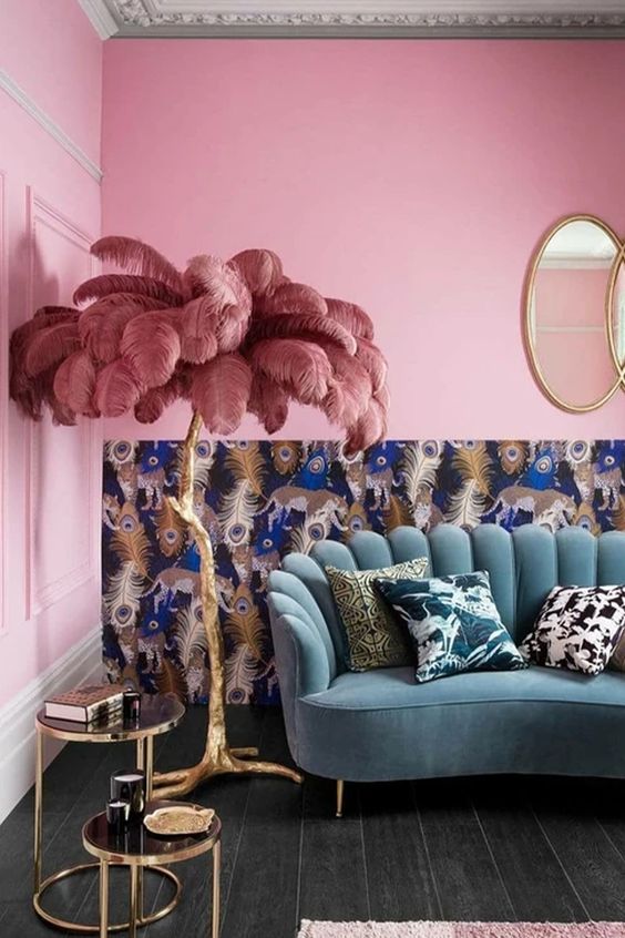 this bold and kitschy lamp will make your space jaw-dropping, it's a gilded branch lamp with dusty pink feathers