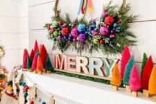 19 an extra bold Christmas mantel with bright bottle brush trees, letters, a wreath with ornaments and greenery, felt balls and wooden Christmas trees