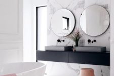 21 a stylish contemporary bathroom with a black floating vanity and black fixtures plus softening blush touches