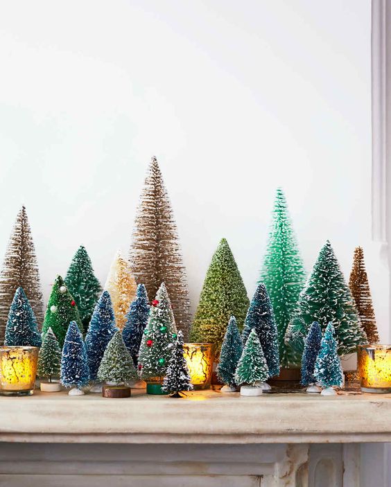 a vintage mantel with colorful bottle brush Christmas trees with bright beads as ornaments and candleholders