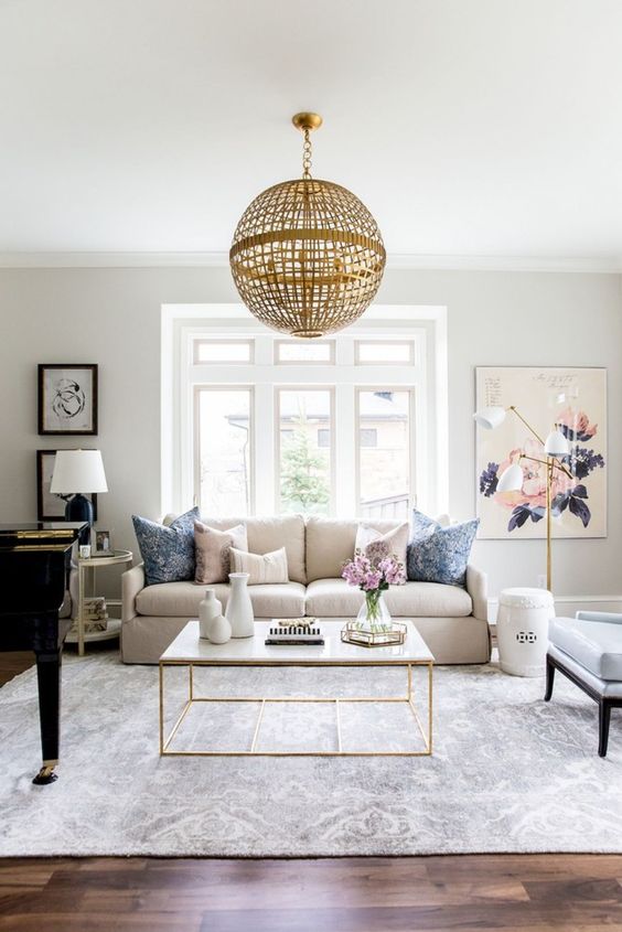 a large neutral blue and whire printed rug is a delicate and chic touch to this modern living room is amazing