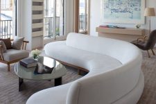 24 a gorgeous curved white sofa takes over the whole living room and adds soft lines and shapes to it