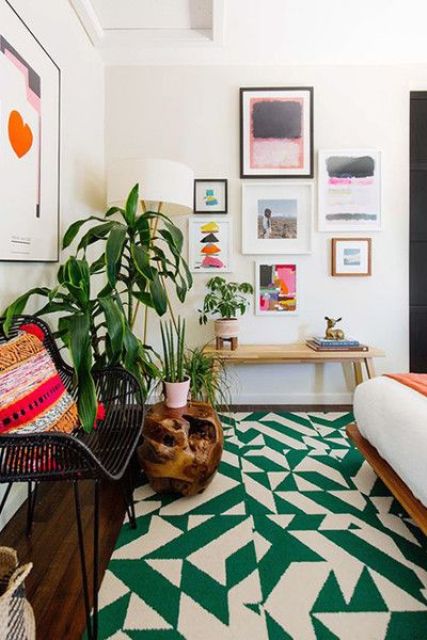 a mid-century modern bedroom with a bold green and white geometric print rug that brings color and pattern to the room