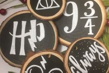 26 chalkboard wood slice Christmas ornaments are a cool and creative idea for a Harry Potter inspired Christmas party