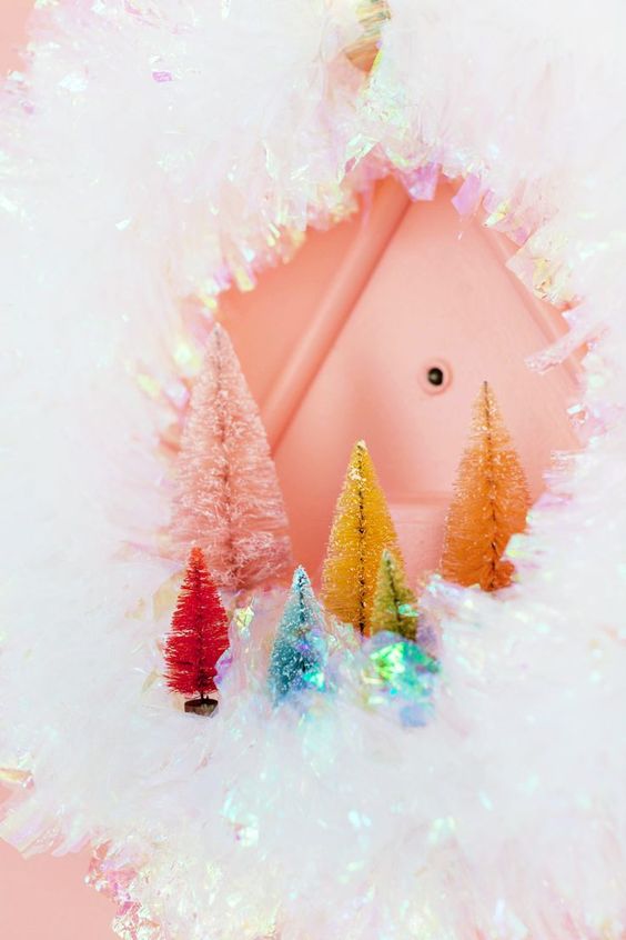 a bright and shiny iridescent wreath with colorful bottle brush trees is a beautiful and cheerful decoration for Christmas