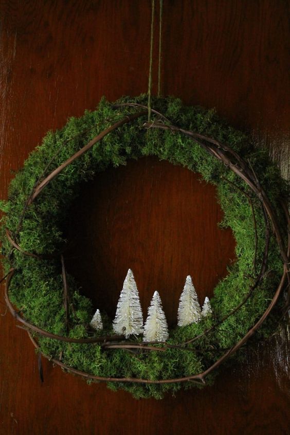 a moss and vine Christmas tree with white bottle brush trees is a lovely natura-inspired idea