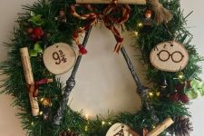 31 a bright Harry Potter Christmas wreath decorated with pinecones, faux berries, wood slices, letters and lights