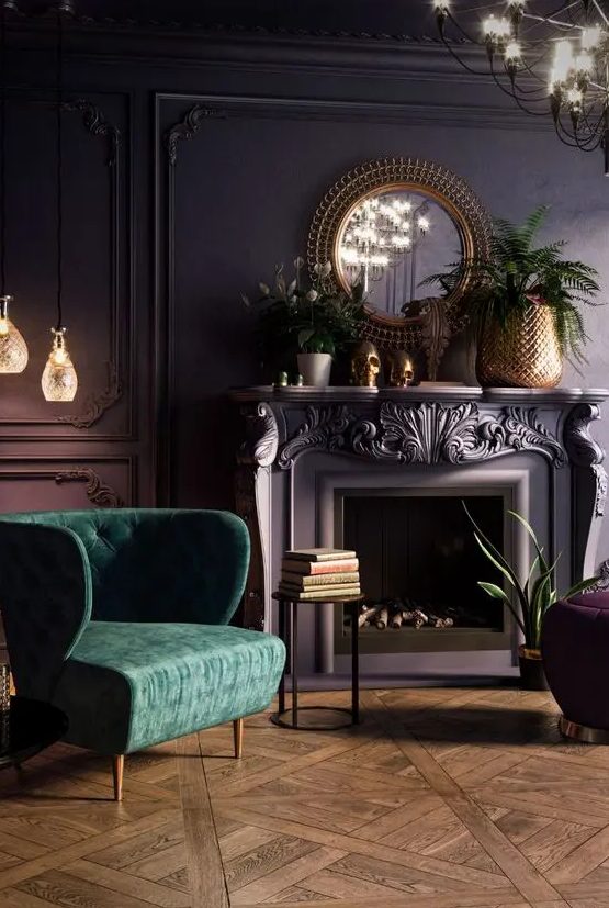 a beautiful vintage living room with a purple accent wall with molding, a fireplace, potted plants and blooms, a chandelier and a green chair