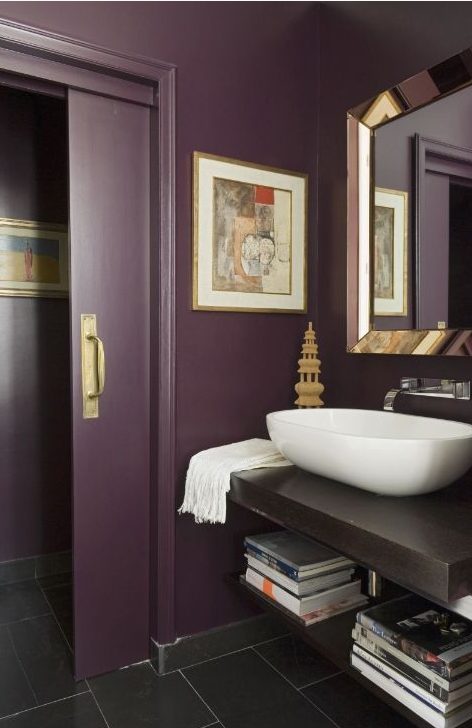 a chic aubergine bathroom, a floating vanity, metallic touches, a vessel sink and sliding doors