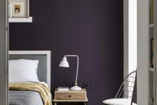 a cute bedroom with a purple wall