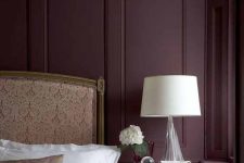 41 a refined and chic bedroom with aubergine walls, a neutral upholstered bed, a vintage nightstand and a lamp is amazing