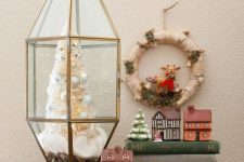 41 an elegant Christmas terrarium with faux snow, a white bottle brush Christmas tree with pearly ornaments