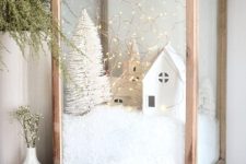 44 an oversized wodoen candleholder with faux snow, mini houses and churches, a mini bottle brush tree and lights