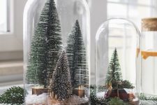 46 cloches with bottle brush Christmas trees, faux snow and a small car are amazing for holiday styling