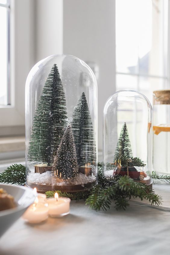 cloches with bottle brush Christmas trees, faux snow and a small car are amazing for holiday styling