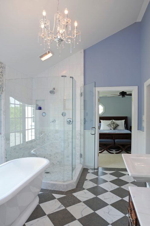 a chic and refined bathroom with periwinkle walls, white wainscoting, a checked floor, a shower, an oval tub and white appliances
