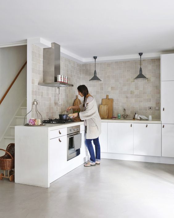 a customized white IKEA kitchen spruced up with neutral tan and beige zellige tiles covering two walls and adding color to the space