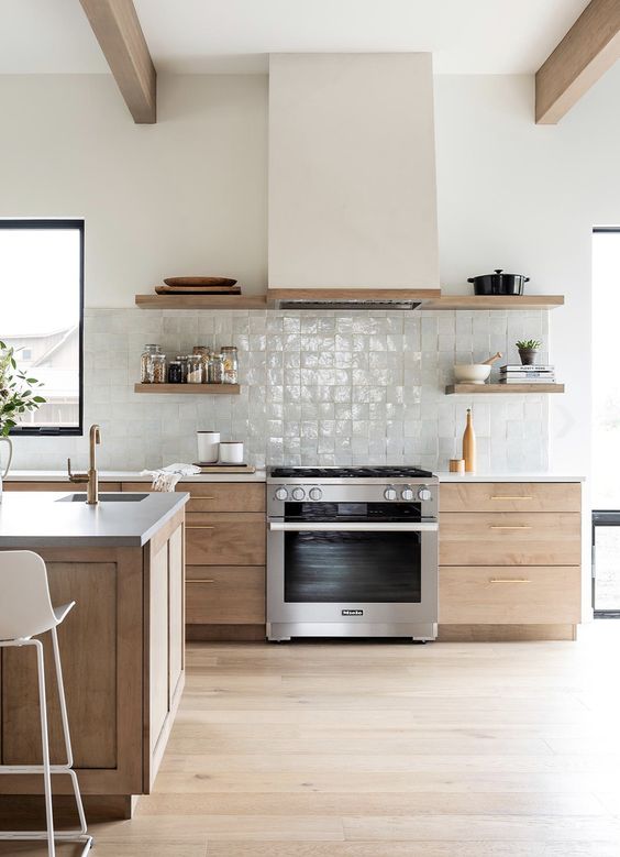 a light-stained kitchen with white stone countertops, a white zellige tile backsplash and stained shelves instead of upper cabinets