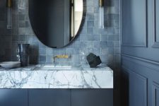 a refined moody bathroom with graphite grey walls and a vanity, a grey zellige tile backsplash and a marble countertop is wow