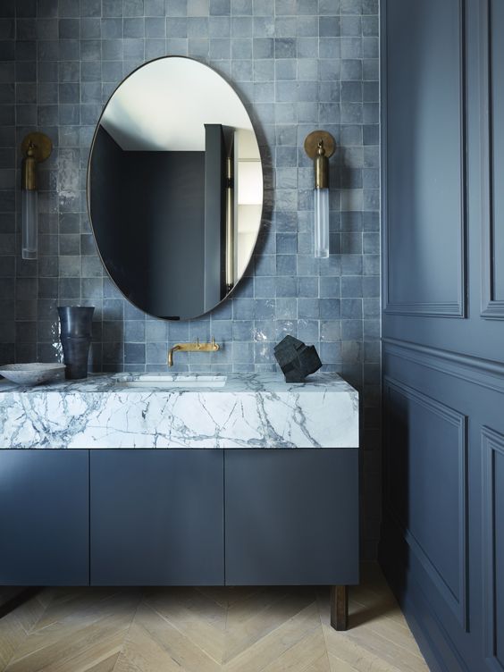 a refined moody bathroom with graphite grey walls and a vanity, a grey zellige tile backsplash and a marble countertop is wow