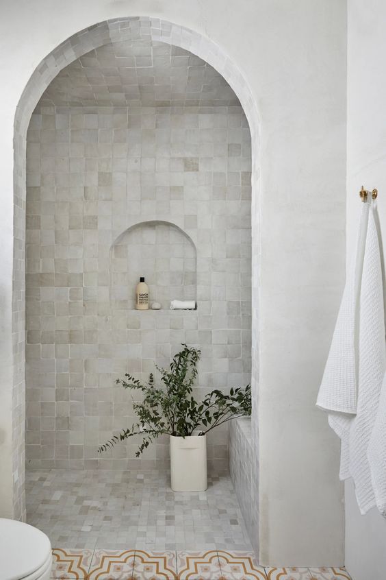 a stylish shower space with creative tiles