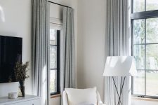 neutral fabric shades and grey curtains add chic and elegance to this beautiful creamy space and add a slight touch of color