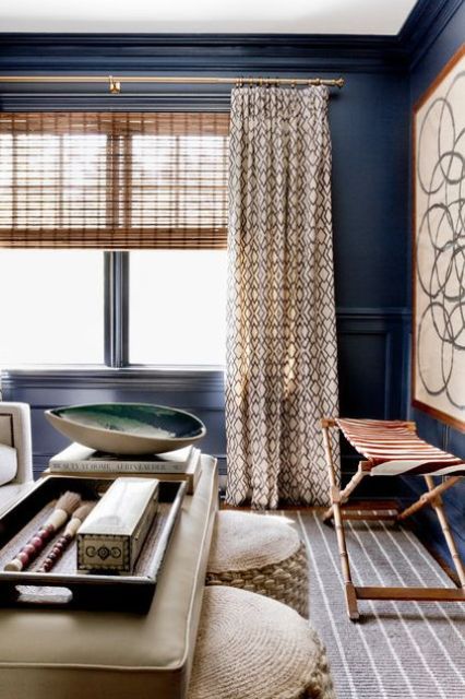 woven shades and printed curtains are a great combo, they bring both texture and print to the space and make the blue walls stand out