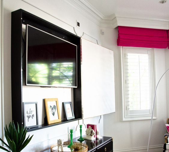 a box with a TV inside and a gorgeous artwork on the outside is a cool idea for every room, especially for a bedroom