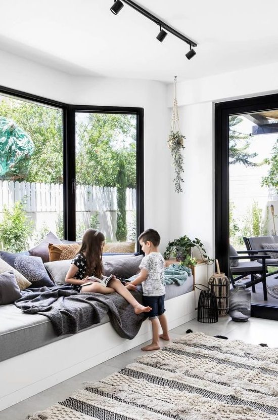 a contemporary space with a bow window and a large and soft daybed on the windowsill is an amazing space to relax