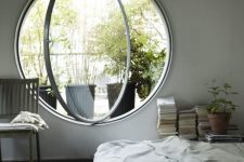 08 a neutral and airy bedroom done with a round pivot window, which allows fresh air in easily