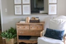 10 a farmhouse living room with vintage furniture, a reclaimed wooden vanity, a TV hidden behind a vintage poster gallery wall
