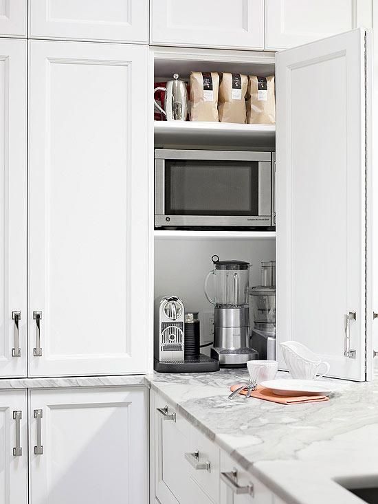 a small and comfortable cabinet with various kitchen appliances and some tea and coffee related stuff is amazing