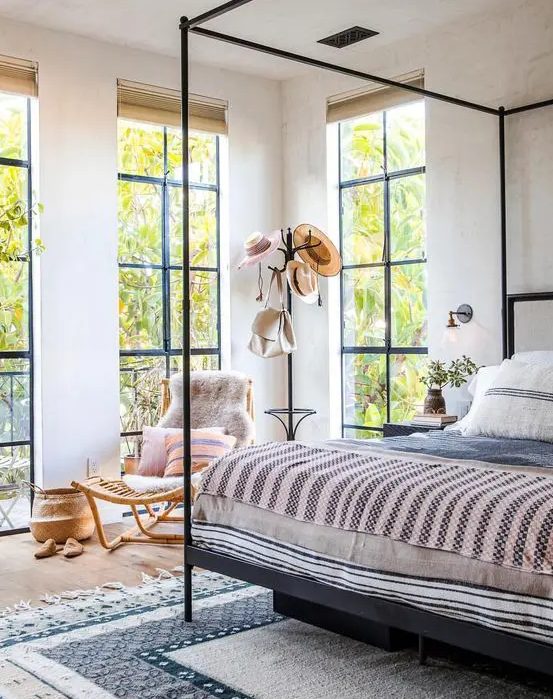 floor to ceiling windows create a light feeling in the bedroom and fill it with natural light
