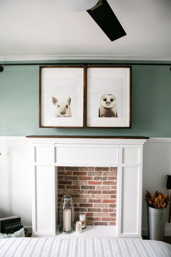 a faux fireplace, a TV hidden with artworks that can be moved to watch the TV is a very cool idea