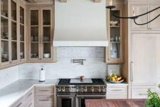 13 a catchy and welcoming kitchen with a whitewashed ceiling and cabinets, with a reclaimed wood floor and a kitchen island with a reddish countertop